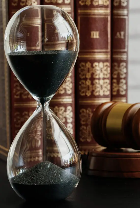 court concept hourglass and judge gavel on table C29WNTL