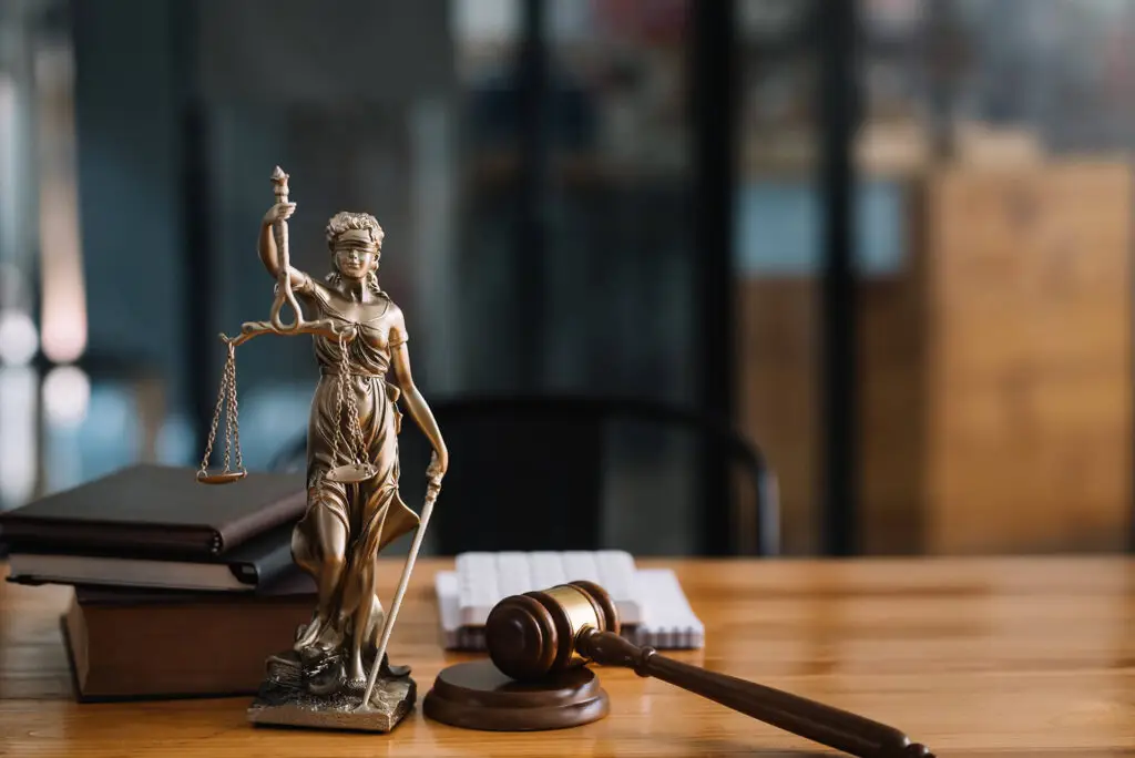 statue of lady justice on desk of a judge or lawye SVECXT5